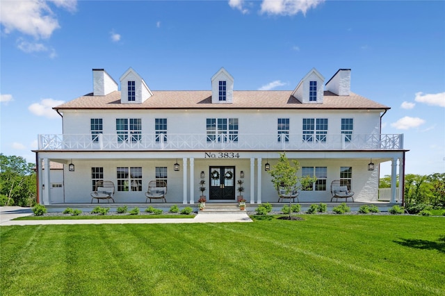 3834 NW 177th Ct, Clive, IA 50325 - view of front of house with a chimney, a balcony, a front lawn, and french doors