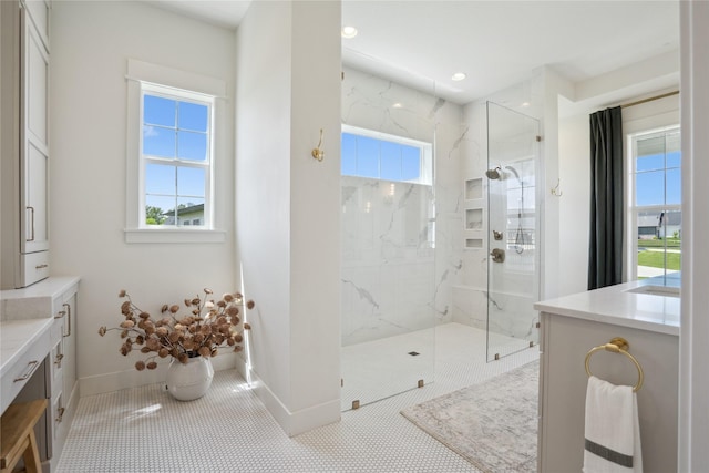 3834 NW 177th Ct, Clive, IA 50325 - bathroom with a marble finish shower, baseboards, vanity, tile patterned floors, and recessed lighting