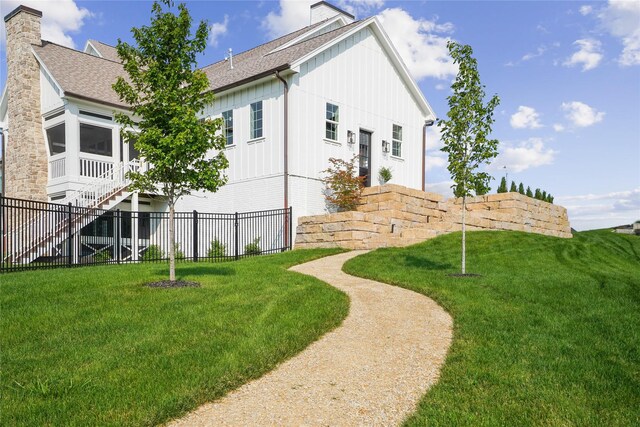 3834 NW 177th Ct, Clive, IA 50325 - view of property exterior featuring a shingled roof, board and batten siding, and a chimney
