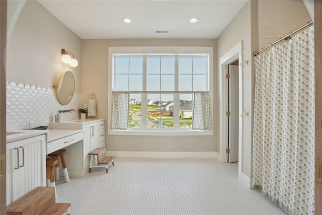 3834 NW 177th Ct, Clive, IA 50325 - full bathroom featuring vanity, tasteful backsplash, a shower with curtain, recessed lighting, and baseboards