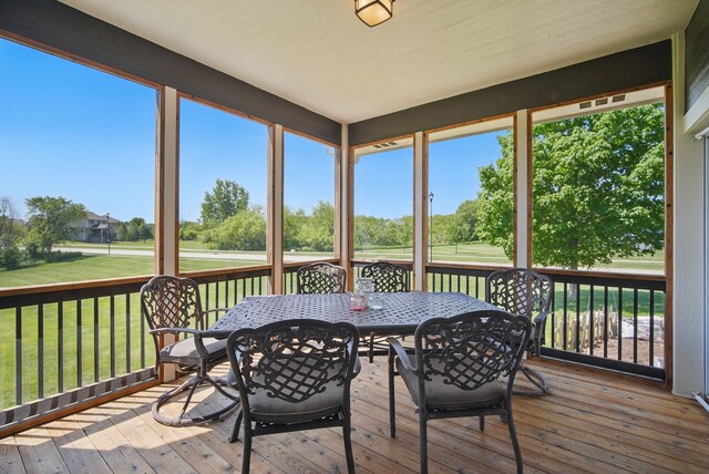 9012 NW 72nd Pl, Johnston, IA 50131 - sunroom featuring outdoor dining area and view of scattered trees