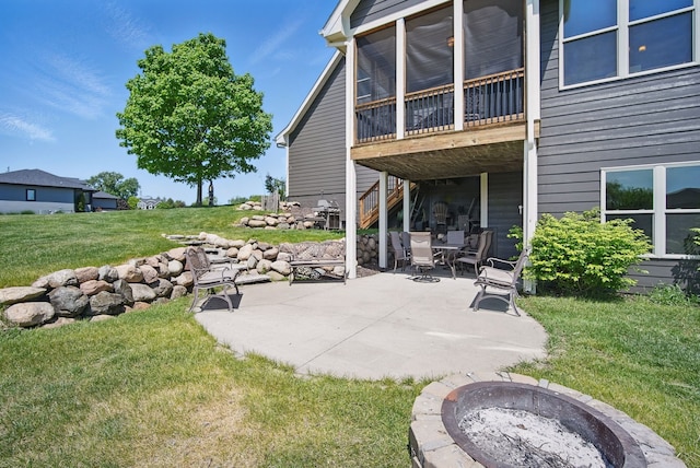 9012 NW 72nd Pl, Johnston, IA 50131 - view of patio featuring an outdoor fire pit, stairway, area for grilling, and a sunroom