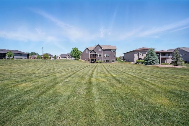 9012 NW 72nd Pl, Johnston, IA 50131 - view of grassy yard featuring a residential view