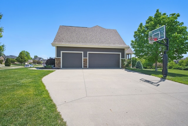 9012 NW 72nd Pl, Johnston, IA 50131 - view of side of property with a lawn, driveway, a garage, and stone siding