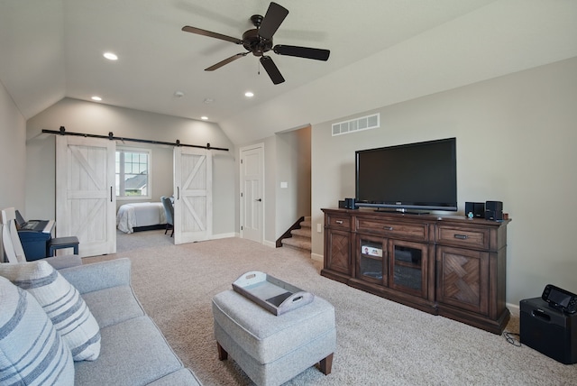 9012 NW 72nd Pl, Johnston, IA 50131 - living room with vaulted ceiling, a barn door, a ceiling fan, light carpet, and recessed lighting