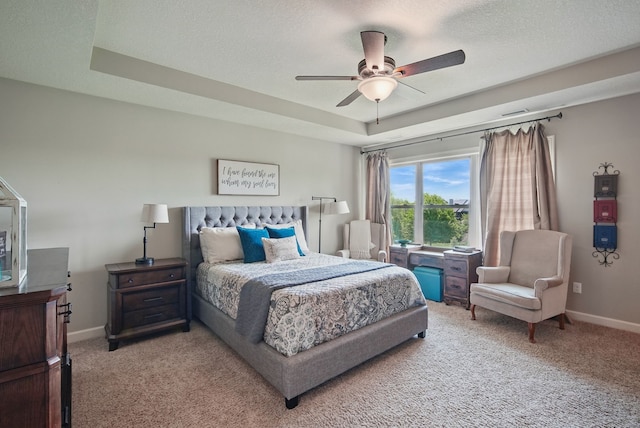 9012 NW 72nd Pl, Johnston, IA 50131 - bedroom with light colored carpet, baseboards, a textured ceiling, a raised ceiling, and ceiling fan