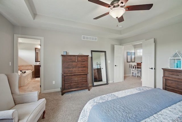 9012 NW 72nd Pl, Johnston, IA 50131 - bedroom with a raised ceiling, baseboards, light carpet, ensuite bath, and a ceiling fan