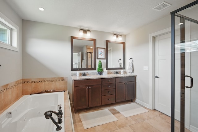 9012 NW 72nd Pl, Johnston, IA 50131 - bathroom featuring double vanity, a shower stall, a tub with jets, tile patterned floors, and recessed lighting