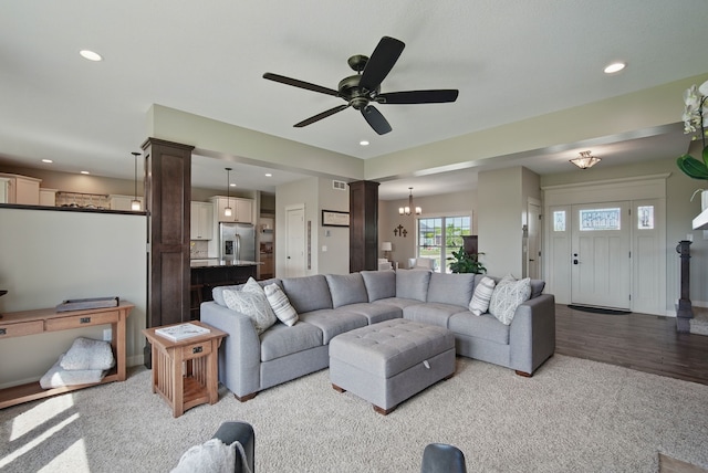 9012 NW 72nd Pl, Johnston, IA 50131 - living room with ornate columns, ceiling fan, recessed lighting, light colored carpet, and a chandelier