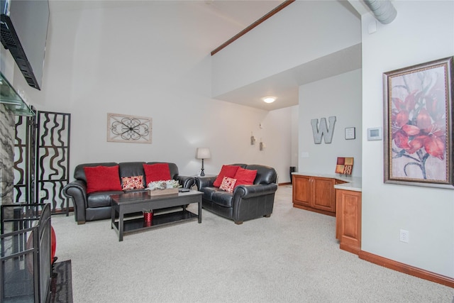 900 67th St Unit 503, West Des Moines, IA 50266 - living area featuring light colored carpet, high vaulted ceiling, and baseboards