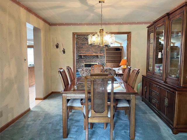 210 E 24th St N, Newton, IA 50208 - carpeted dining area featuring a chandelier, wallpapered walls, a brick fireplace, and ornamental molding
