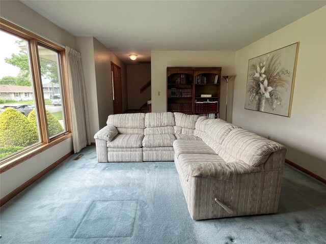 210 E 24th St N, Newton, IA 50208 - carpeted living area with baseboards and stairs