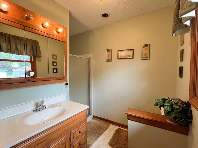 210 E 24th St N, Newton, IA 50208 - full bath with a stall shower, vanity, tile patterned floors, and a textured ceiling