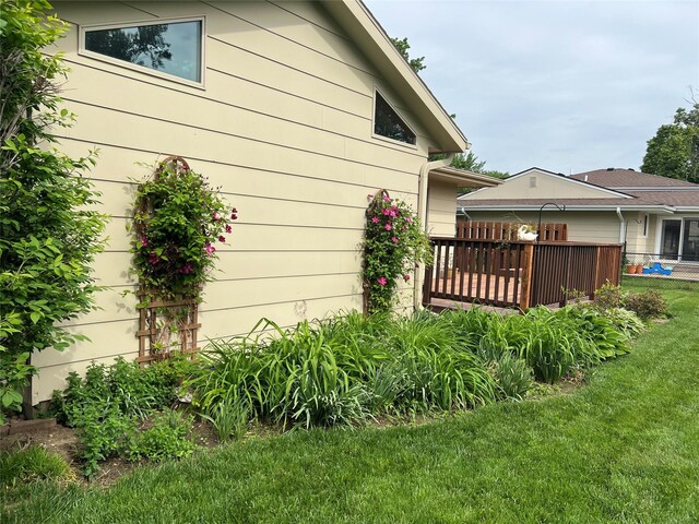 210 E 24th St N, Newton, IA 50208 - back of property with a lawn and a deck