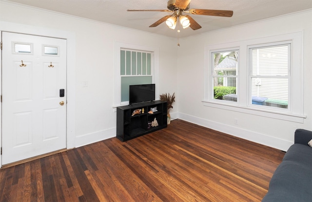 216 56th St, Des Moines, IA 50312 - unfurnished living room with ornamental molding, dark wood-style floors, baseboards, and ceiling fan