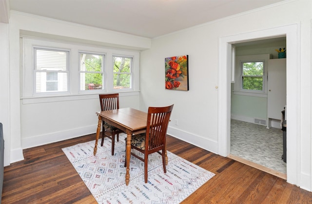 216 56th St, Des Moines, IA 50312 - dining space featuring ornamental molding, dark wood-style floors, and baseboards