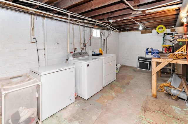 216 56th St, Des Moines, IA 50312 - unfinished below grade area with washing machine and clothes dryer, refrigerator, and concrete block wall
