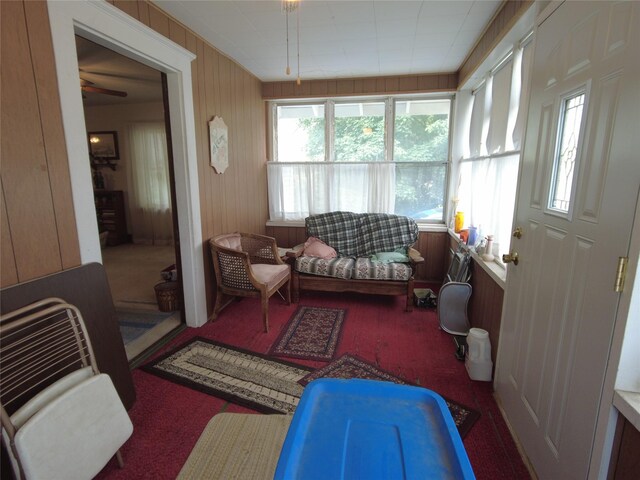 627 7th St, Nevada, IA 50201 - sunroom featuring carpet and wooden walls