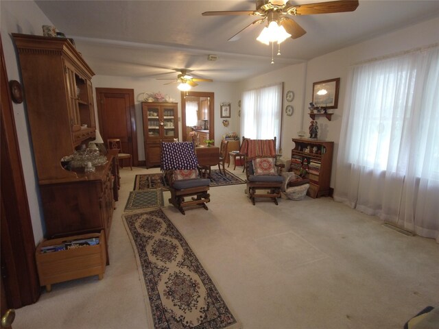 627 7th St, Nevada, IA 50201 - living area featuring light colored carpet and a ceiling fan