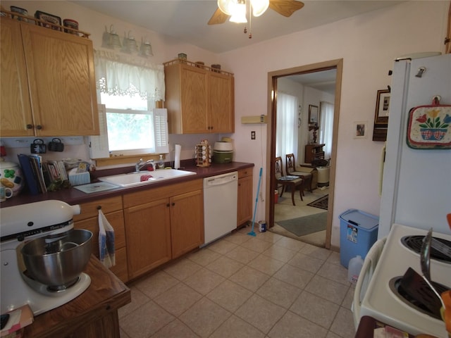 627 7th St, Nevada, IA 50201 - kitchen with white appliances, a sink, ceiling fan, and dark countertops