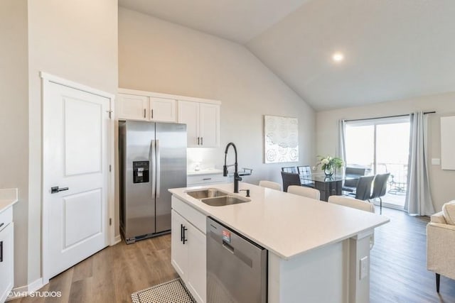 14225 Walnut Meadows Dr, Urbandale, IA 50323 - kitchen featuring appliances with stainless steel finishes, a sink, white cabinetry, light wood-style floors, and light countertops