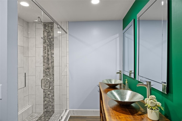304 11th St SE, Altoona, IA 50009 - full bathroom featuring a stall shower, recessed lighting, double vanity, and baseboards