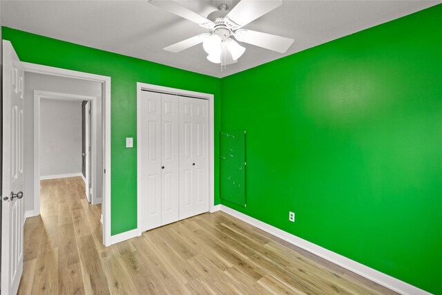 304 11th St SE, Altoona, IA 50009 - unfurnished bedroom with wood finished floors, a closet, baseboards, and ceiling fan