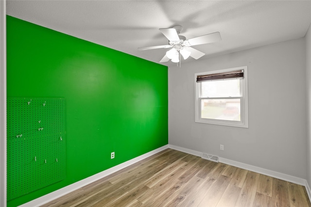 304 11th St SE, Altoona, IA 50009 - unfurnished room featuring wood finished floors, baseboards, and ceiling fan