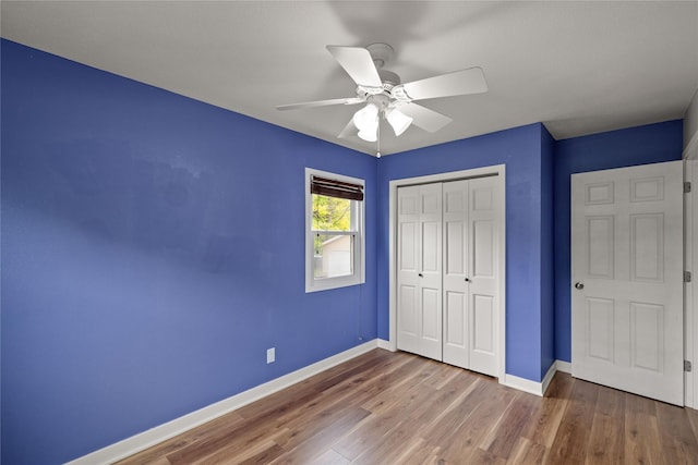 304 11th St SE, Altoona, IA 50009 - unfurnished bedroom featuring a closet, baseboards, wood finished floors, and ceiling fan