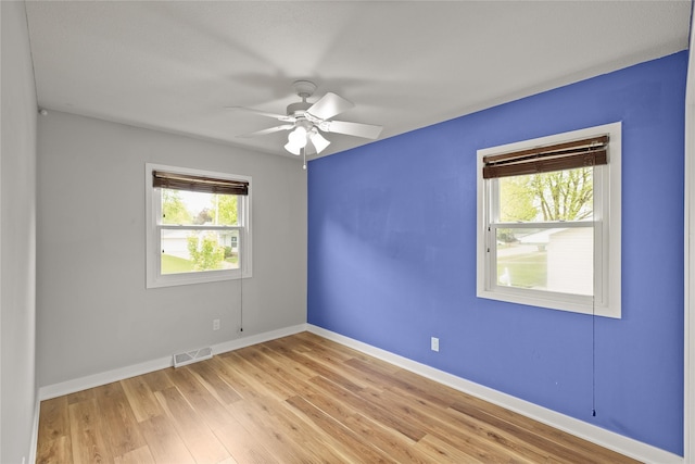 304 11th St SE, Altoona, IA 50009 - empty room with light wood-style floors, a ceiling fan, and baseboards