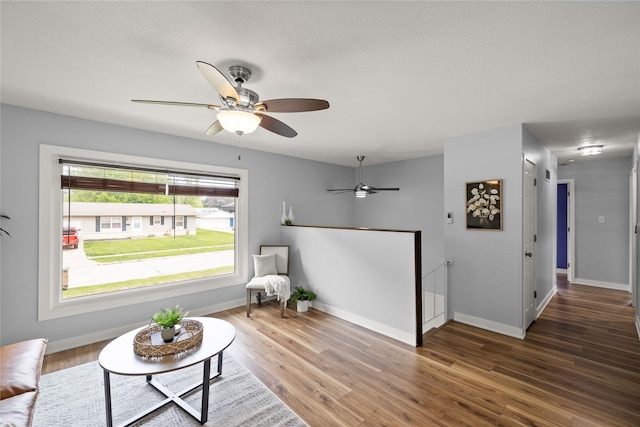304 11th St SE, Altoona, IA 50009 - sitting room featuring ceiling fan, wood finished floors, and baseboards