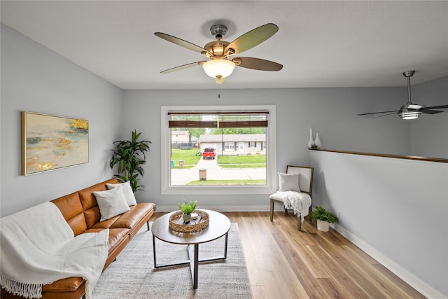 304 11th St SE, Altoona, IA 50009 - living room featuring ceiling fan, wood finished floors, and baseboards