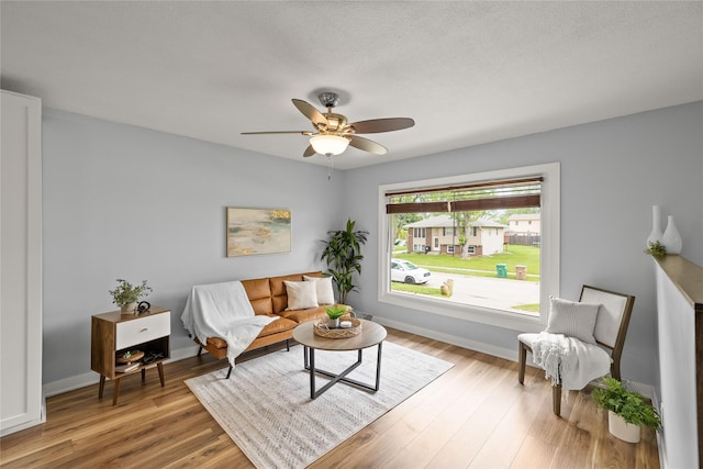 304 11th St SE, Altoona, IA 50009 - living area with wood finished floors, ceiling fan, and baseboards
