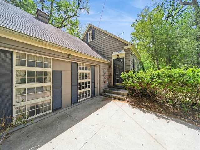 3110 Saint Johns Rd, Des Moines, IA 50312 - view of patio / terrace with driveway and an attached garage