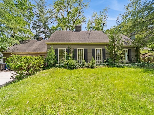 3110 Saint Johns Rd, Des Moines, IA 50312 - rear view of house featuring a chimney and a yard