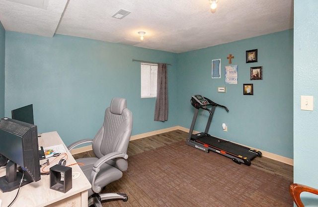2518 E 39th Ct, Des Moines, IA 50317 - office area with baseboards, a textured ceiling, and wood finished floors
