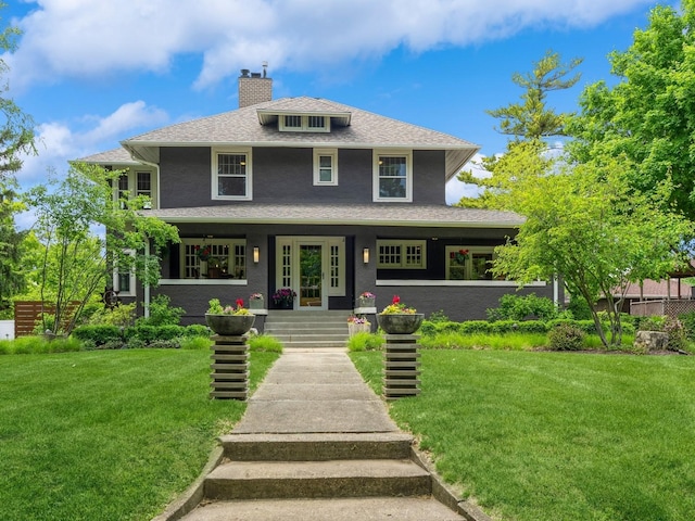 912 45th St, Des Moines, IA 50312 - traditional style home featuring a chimney, a front yard, covered porch, and a shingled roof