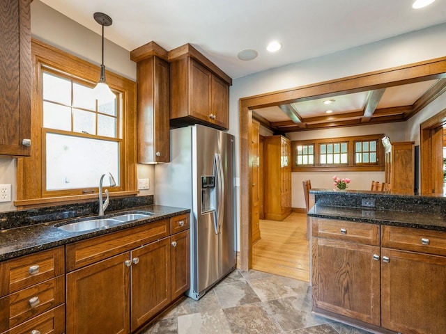 912 45th St, Des Moines, IA 50312 - kitchen with a sink, stainless steel fridge with ice dispenser, healthy amount of natural light, brown cabinetry, and beamed ceiling