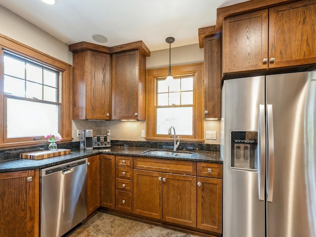 912 45th St, Des Moines, IA 50312 - kitchen featuring appliances with stainless steel finishes, a sink, and brown cabinets