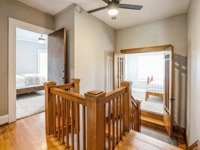 912 45th St, Des Moines, IA 50312 - hall with an upstairs landing, light wood-style floors, baseboards, and light colored carpet