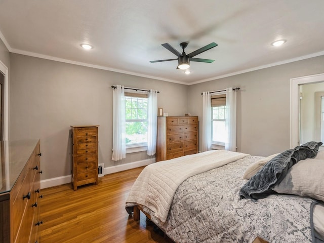 912 45th St, Des Moines, IA 50312 - bedroom featuring multiple windows, light wood-style flooring, baseboards, ornamental molding, and recessed lighting