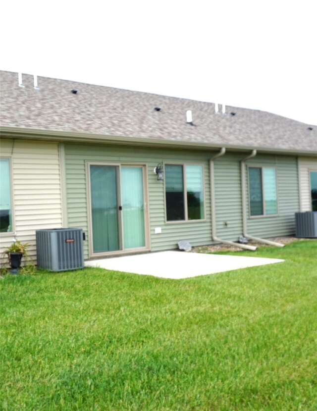 507 W Madison St, Winterset, IA 50273 - rear view of property featuring cooling unit, a yard, a patio, and a shingled roof
