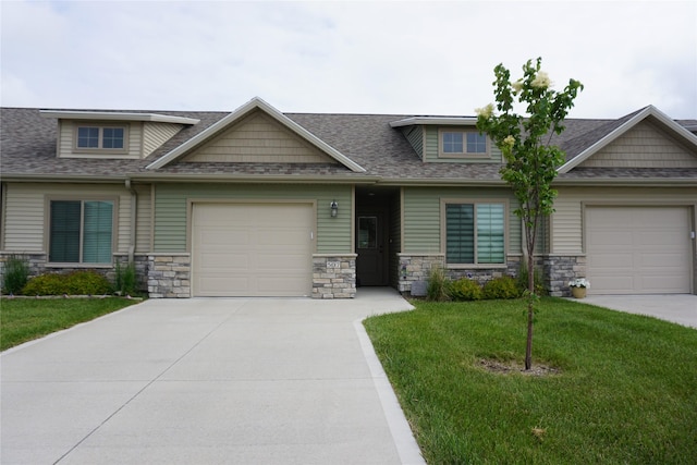507 W Madison St, Winterset, IA 50273 - craftsman house with driveway, stone siding, a front yard, and a garage