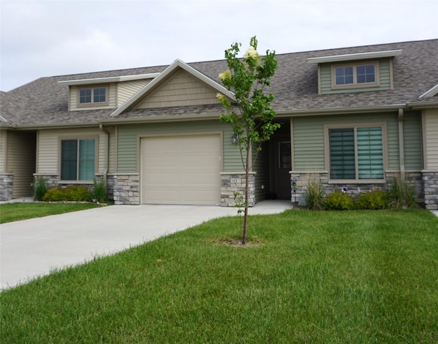 507 W Madison St, Winterset, IA 50273 - craftsman-style house featuring concrete driveway, an attached garage, stone siding, and a front yard