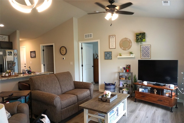 507 W Madison St, Winterset, IA 50273 - living room featuring light wood finished floors, vaulted ceiling, and ceiling fan