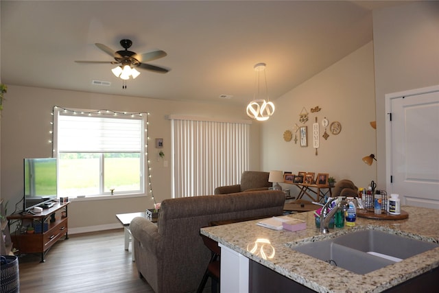 507 W Madison St, Winterset, IA 50273 - living room featuring wood finished floors, a ceiling fan, and baseboards