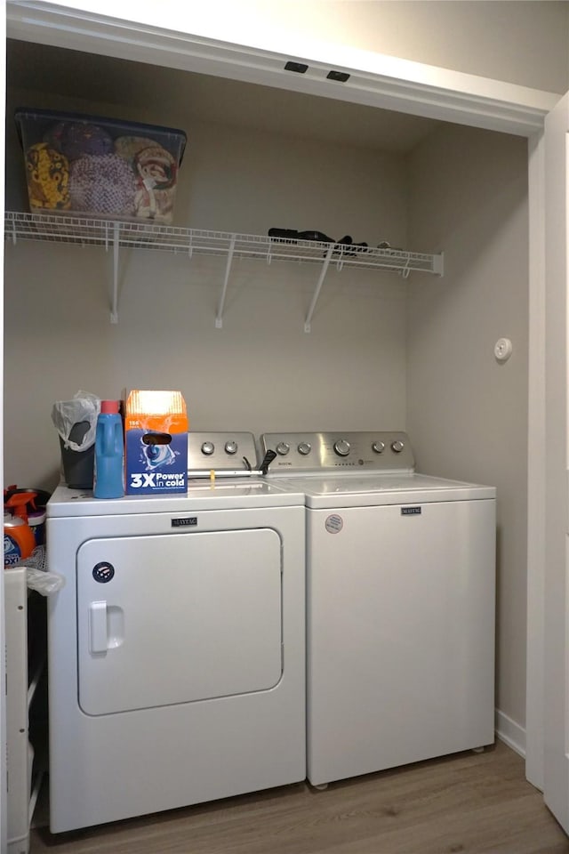 507 W Madison St, Winterset, IA 50273 - laundry room featuring washing machine and dryer and light wood-type flooring