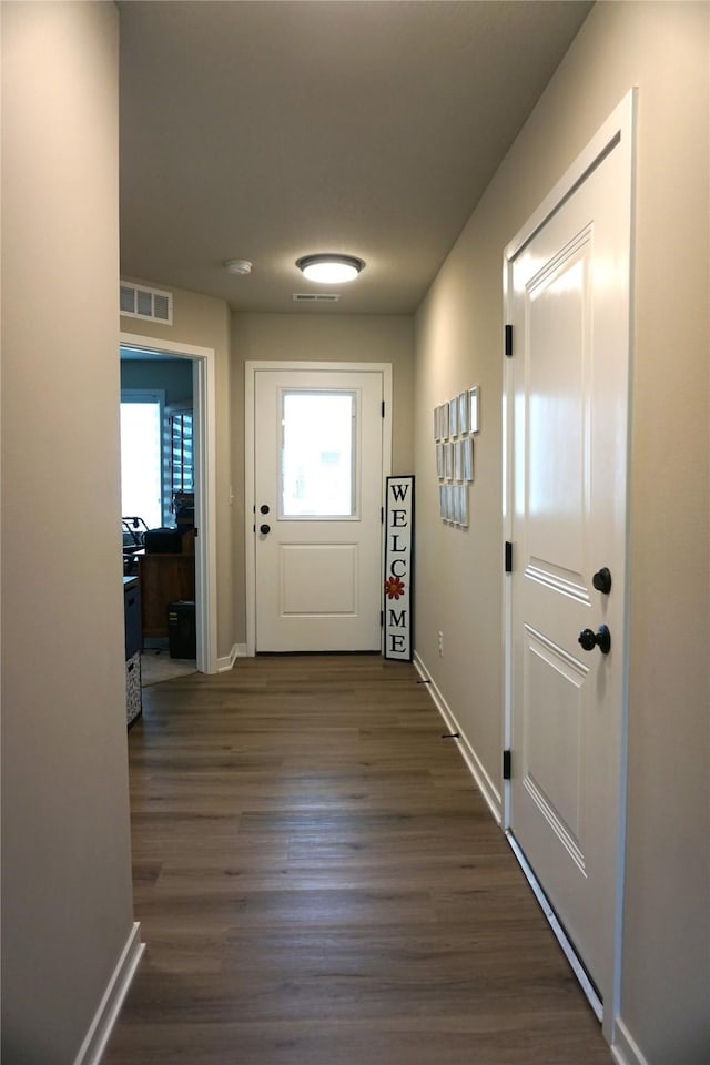 507 W Madison St, Winterset, IA 50273 - entryway featuring healthy amount of natural light, baseboards, and dark wood-type flooring