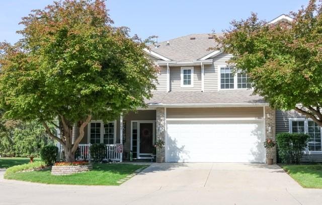 1150 S 52nd St Unit 205, West Des Moines, IA 50265 - view of front facade with driveway, covered porch, and an attached garage