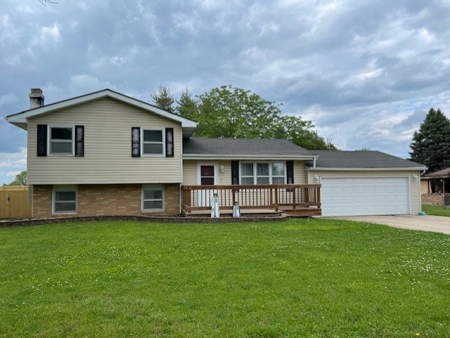 711 SW 2nd St, Stuart, IA 50250 - tri-level home with a garage, a front yard, driveway, a wooden deck, and a chimney